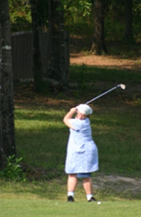 A girl swings a golf club.
