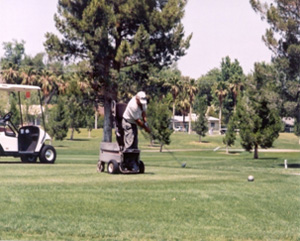 A man swings at a golf ball.
