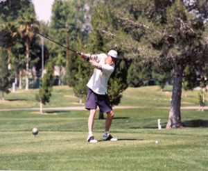An upper limb amputee swings at a ball.
