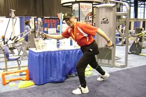 An older adult exercises with exercise bands at a fitness conference.