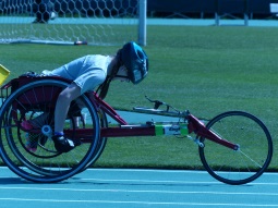 a participant uses a racing chair in a track event