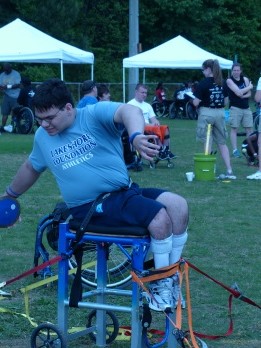 a participant uses an assistive device to compete in the field event "discus"