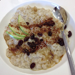 bowl of cinnamon oatmeal with apples and raisins