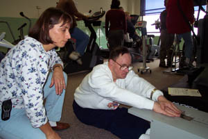 Picture of a personal trainer working with a  person with a disability in a fitness center.