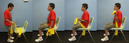 Child with Spina Bifida is performing an Elbow Flexion exercise from a seated position.