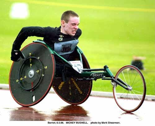 Image of a young man with an amputation using a lumbar sacral spinal agenesis using a T53 wheelchair racer.