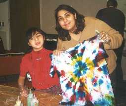 A child with a disability doing arts and crafts with an adult.