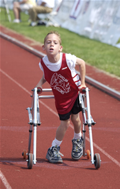 A young boy using a walker during a track and field event